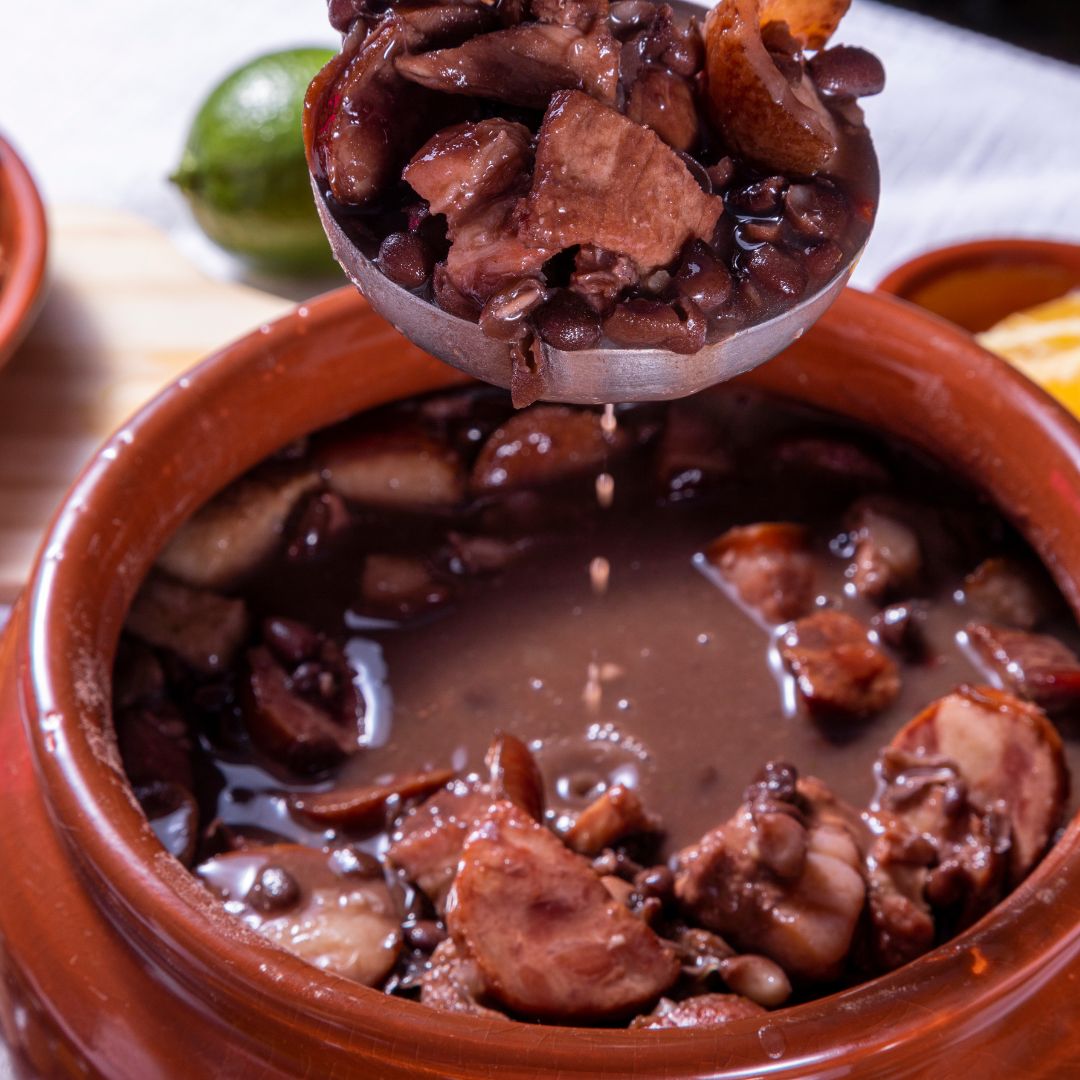 Rich Brazilian Feijoada black bean stew served in a clay pot